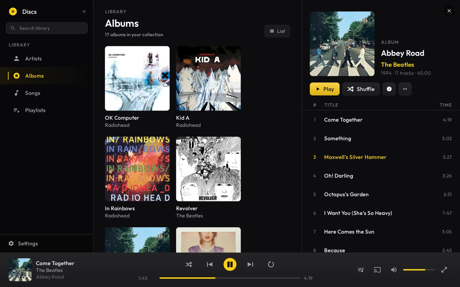 Discs on a tablet showing the album library on the left and the Abbey Road tracklist open on the right